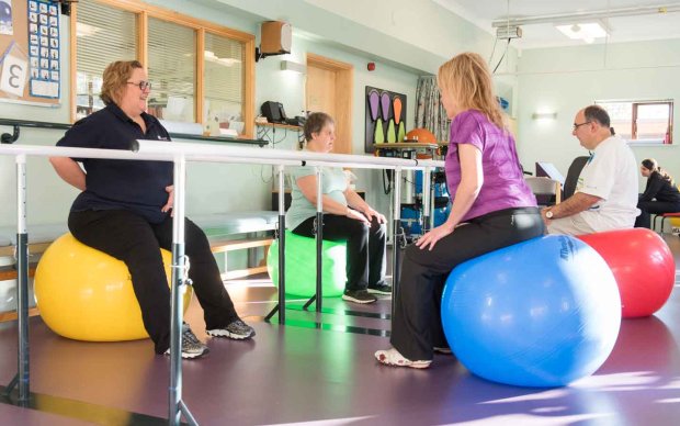 Photo: Group of people with MS exercising with exercise balls together
