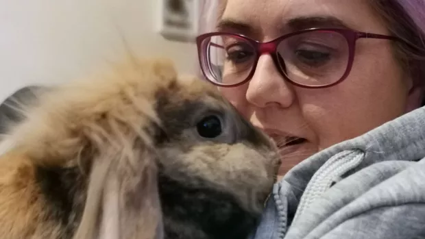 Fluffy Binky the Bunny cuddles up to owner Caroline