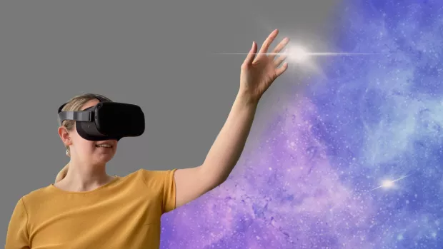 Researcher Amy reaches for a star in a virtual reality scene 