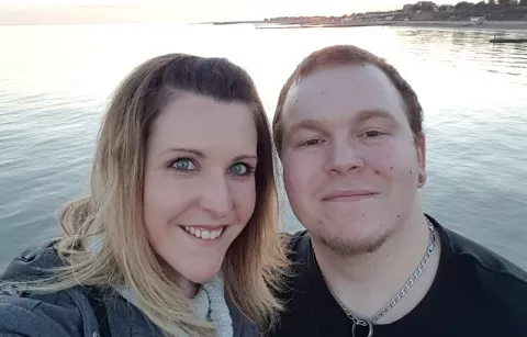 Photo: James who has MS and his wife Katie at sunset by the sea