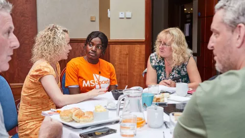 Volunteers at a local MS group meeting talking