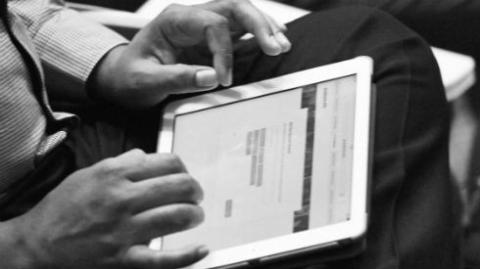 a Picture of a person completing a questionnaire  on a tablet